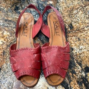 Made in Brazil, red leather upper, embossed tooling, stitching trim.